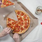 Top view of friends sharing pepperoni pizza and enjoying Coca Cola. - Photo by cottonbro studio on Pexels
