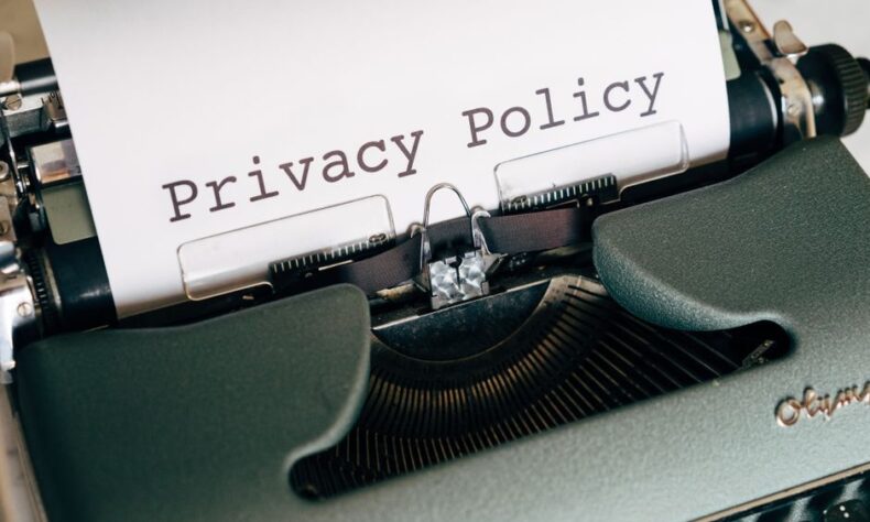 Close-up of a vintage typewriter featuring a privacy policy document in focus, highlighting classic technology. - Photo by Markus Winkler on Pexels